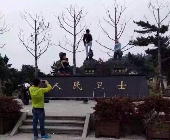 男子腳踩消防烈士銅像拍照